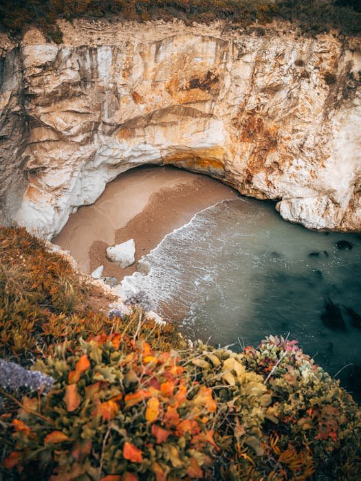 Aerial coastal cove with limestone cliffs